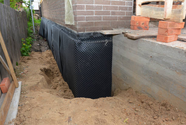 SJ Waterproofing Pros technician performing targeted Emergency Waterproofing assessment in Clarksburg, MD